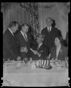 Estes Kefauver and his wife Nancy Kefauver seated at a table, with three men behind them