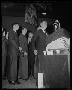 Adlai Stevenson at podium, with his sons behind him