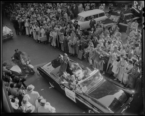 Adlai Stevenson in convertible with Foster Furcolo, John F. Kennedy and two others, surrounded by a crowd