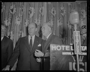 Adlai Stevenson and Mayor John B. Hynes standing by a Statler Hotel podium