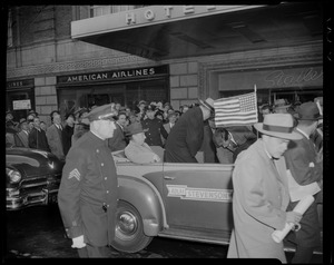 Adlai Stevenson in a convertible, driving by Statler Hotel