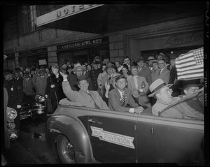 Adlai Stevenson waving in convertible with John Kennedy and others