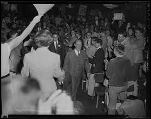 Adlai Stevenson walking through crowd at a rally