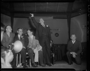 Adlai Stevenson standing on stage and waving