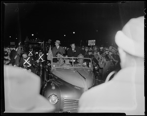 Adlai Stevenson and Paul Dever in car moving through parade with police escort