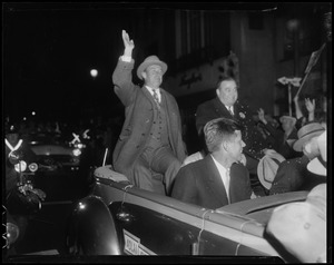 Adlai Stevenson and Paul Dever in convertible moving through parade