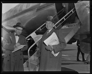 Adlai Stevenson standing by stairs leading to American Airlines airplane