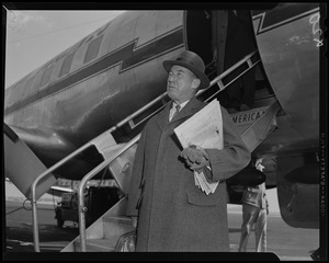 Adlai Stevenson standing by stairs leading to American Airlines airplane