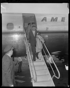 Adlai Stevenson walking down staircase of American Airlines airplane