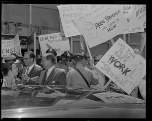 Adlai Stevenson getting ready to enter the car, surrounded by supporters