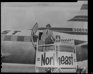 Adlai Stevenson, exiting a Northeast Airlines airplane