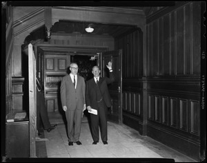 Adlai Stevenson standing with another man in a hallway