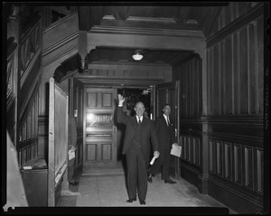 Adlai Stevenson waving in a hallway