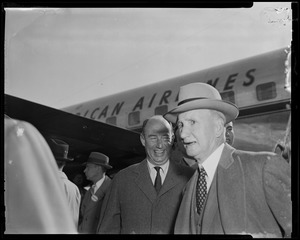 Adlai Stevenson standing outside of airplane with another man