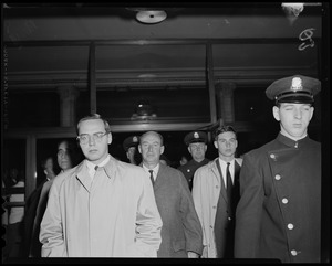 Borden Stevenson, Adlai Stevenson and John Fell Stevenson walking through a building with police escorts