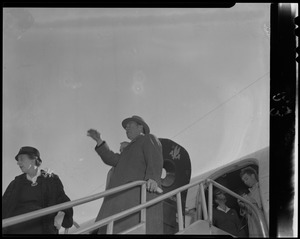 Adlai Stevenson standing on airplane stairs