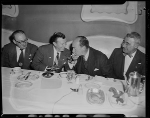 Adlai Stevenson and three others seated at a dining table