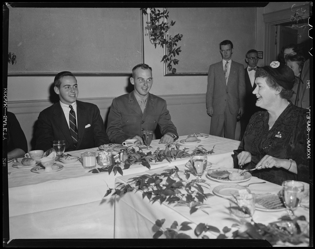 Borden Stevenson and Adlai Stevenson III seated at a dinner table with ...