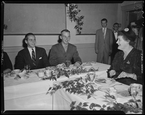 Borden Stevenson and Adlai Stevenson III seated at a dinner table with a woman