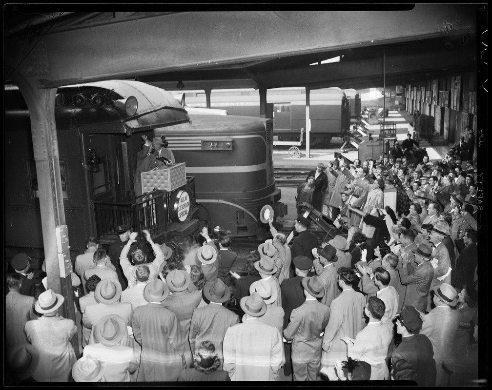Adlai Stevenson addressing a crowd from the back of "Adlai Stevenson Special" train in a railroad station