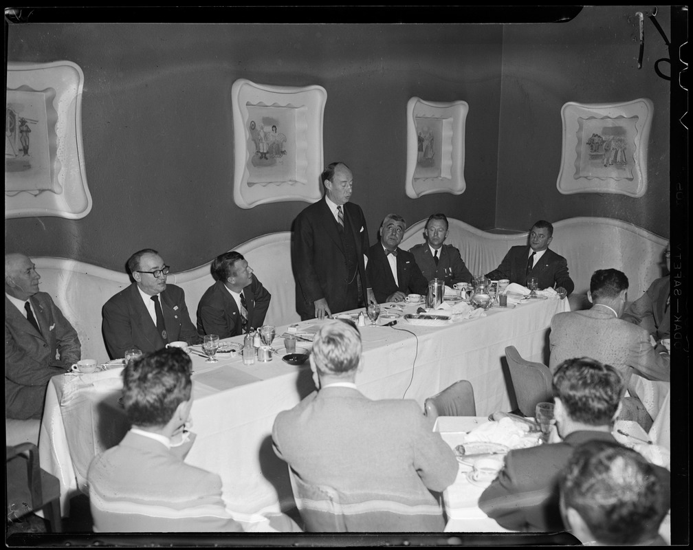 Adlai Stevenson addressing a group of people at a dinner table