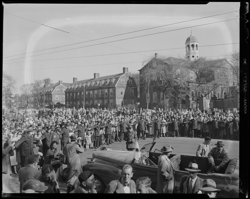 Police managing crowd of people standing near Harvard University campus