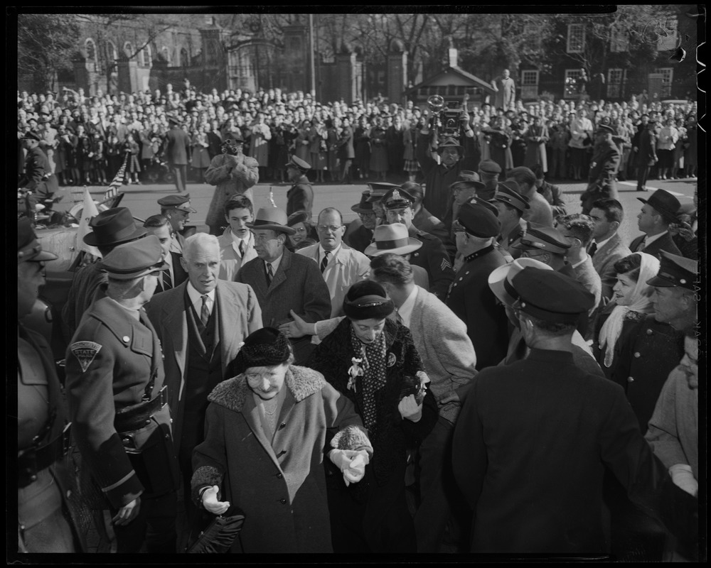 Adlai Stevenson and several others walking through a crowd