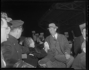 Adlai Stevenson greeting a woman beside him
