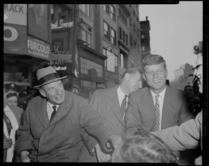 Adlai Stevenson and John F. Kennedy in car greeting supporters