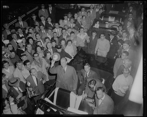 View of Adlai Stevenson standing in a car and the people surrounding him from above