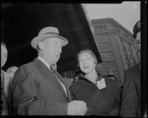 Adlai Stevenson and a woman standing outside