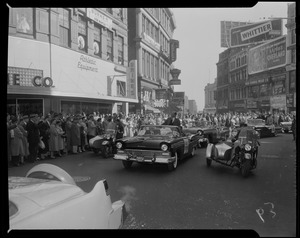 Adlai Stevenson in car in a parade with crowds on either side