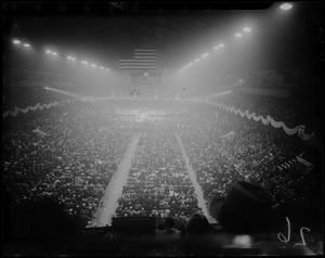 View of a stadium filled with people and a "Dewey - Warren" banner hanging above
