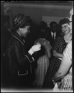 Queen Sirikit of Thailand holding a glass and standing with other women