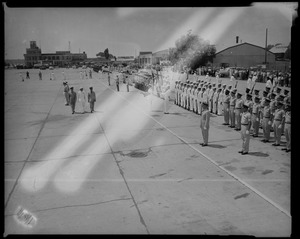 Groups of uniformed people standing at attention upon arrival of King Bhumibol Adulyadej (right)