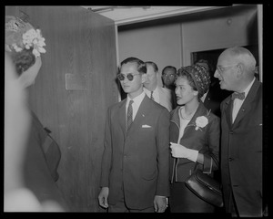 King Bhumibol Adulyadej and Queen Sirikit of Thailand walking through a doorway