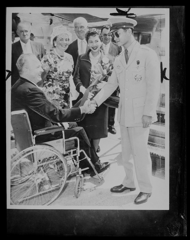 King Bhumibol Adulyadej of Thailand shaking hands with Mayor Collins