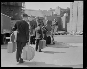 Men loading truck with luggage