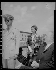 Queen Sirikit of Thailand with flowers standing behind King Bhumibol Adulyadej and Mayor Collins
