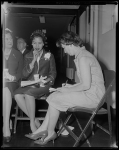 Queen Sirikit of Thailand talking to a woman who is taking notes