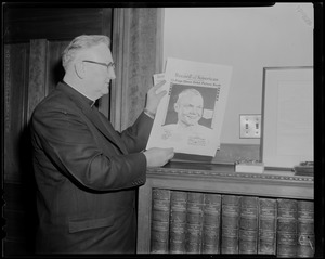 Man posing with copy of the Record American Glenn Orbit Picture Book