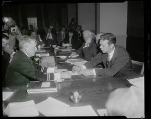 Two men discussing a document at Black Falcon, S.S. Norwegian ship explosion hearing