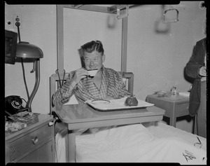 Arthur Godfrey in his hospital bed, drinking from a tea cup