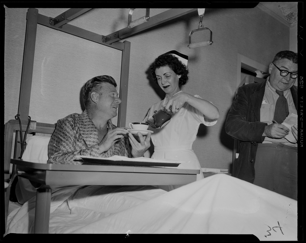 Arthur Godfrey smiling at nurse as she pours from the tea pot