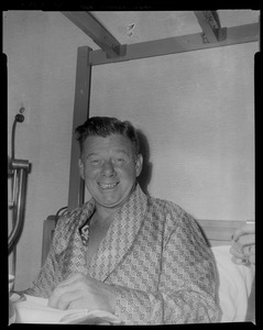 Arthur Godfrey smiling from hospital bed