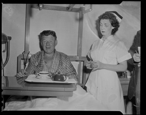 Arthur Godfrey with nurse standing to his left