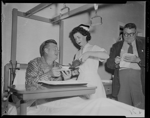 Nurse pouring tea for Arthur Godfrey