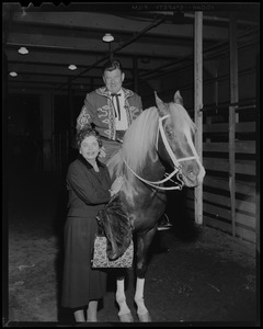 Arthur Godfrey on his horse "Goldie" standing next to Mrs. James Hallett