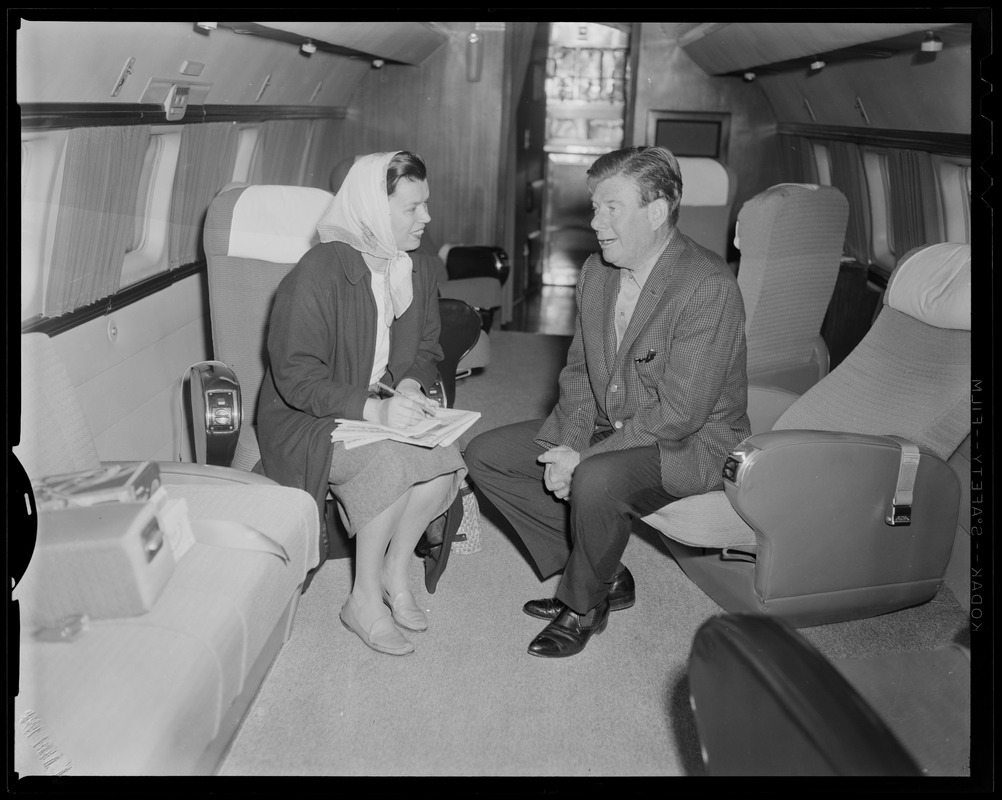 Arthur Godfrey and Loretta McLaughlin talking on an airplane