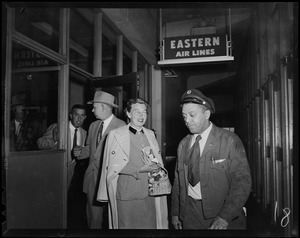 Mrs. Arthur Godfrey walking out of the Eastern Air Lines terminal